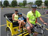 Man With Bike Cart Smiles with Riders