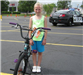 Young Girl Stands Next to Bike