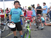 Boy Smiles While Holding Helmet and Bike