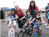Children On Bikes Smile Before Entering Course