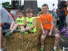 Children Smile Together While on Hay Bales