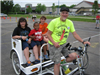 Man With Bike Cart Smiles With Children