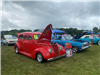 Rows of Vintage Cars With Their Hoods Open at Car Show 2025