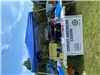 Vendors Set Up Under a Blue Tent At Copley Community Park on Saturday For Heritage Days 2025