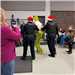 An officer stands on either side of a handcuffed Grinch