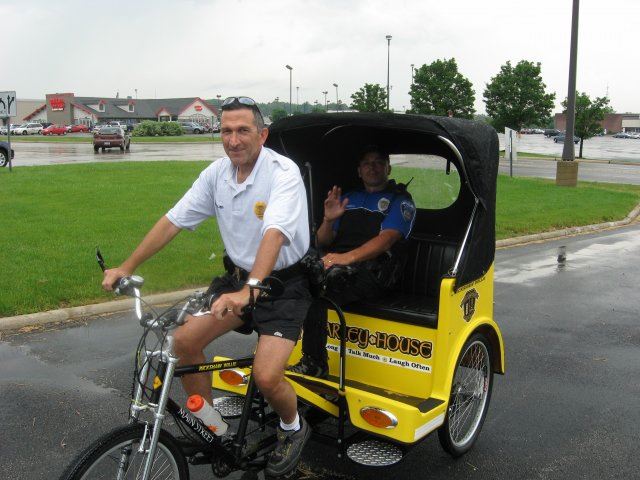 Officers Riding Bike With Cart Pulling Behind