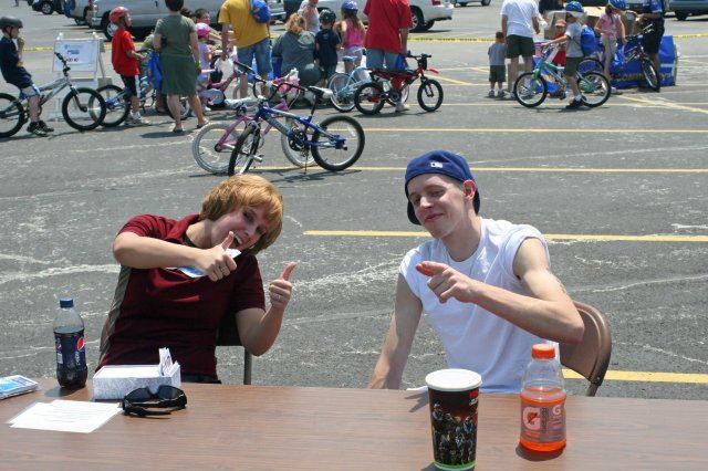 Volunteers Wait at Table and Smile for Camera