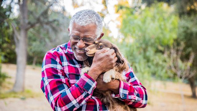 hero-elder-man-snuggling-dog-outside