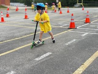 Safety Town Student Rides Scooter on Day 1 of Safety Town 2025