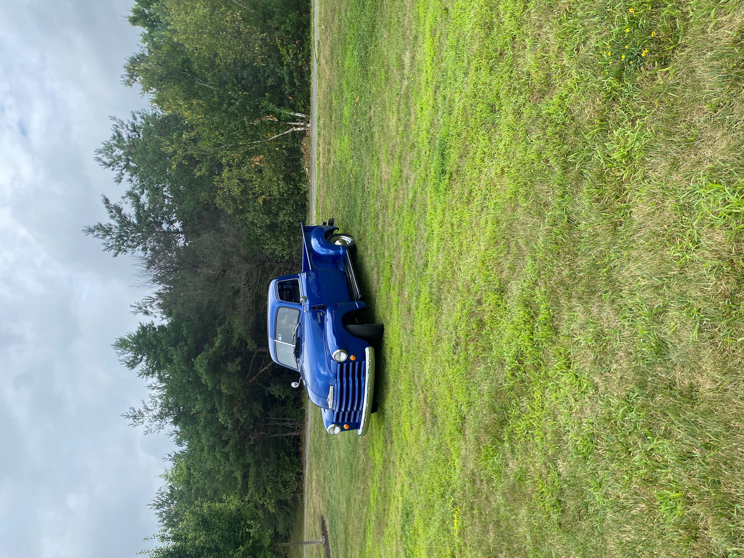 A Vintage Blue Pickup Truck On Display at Car Show 2025