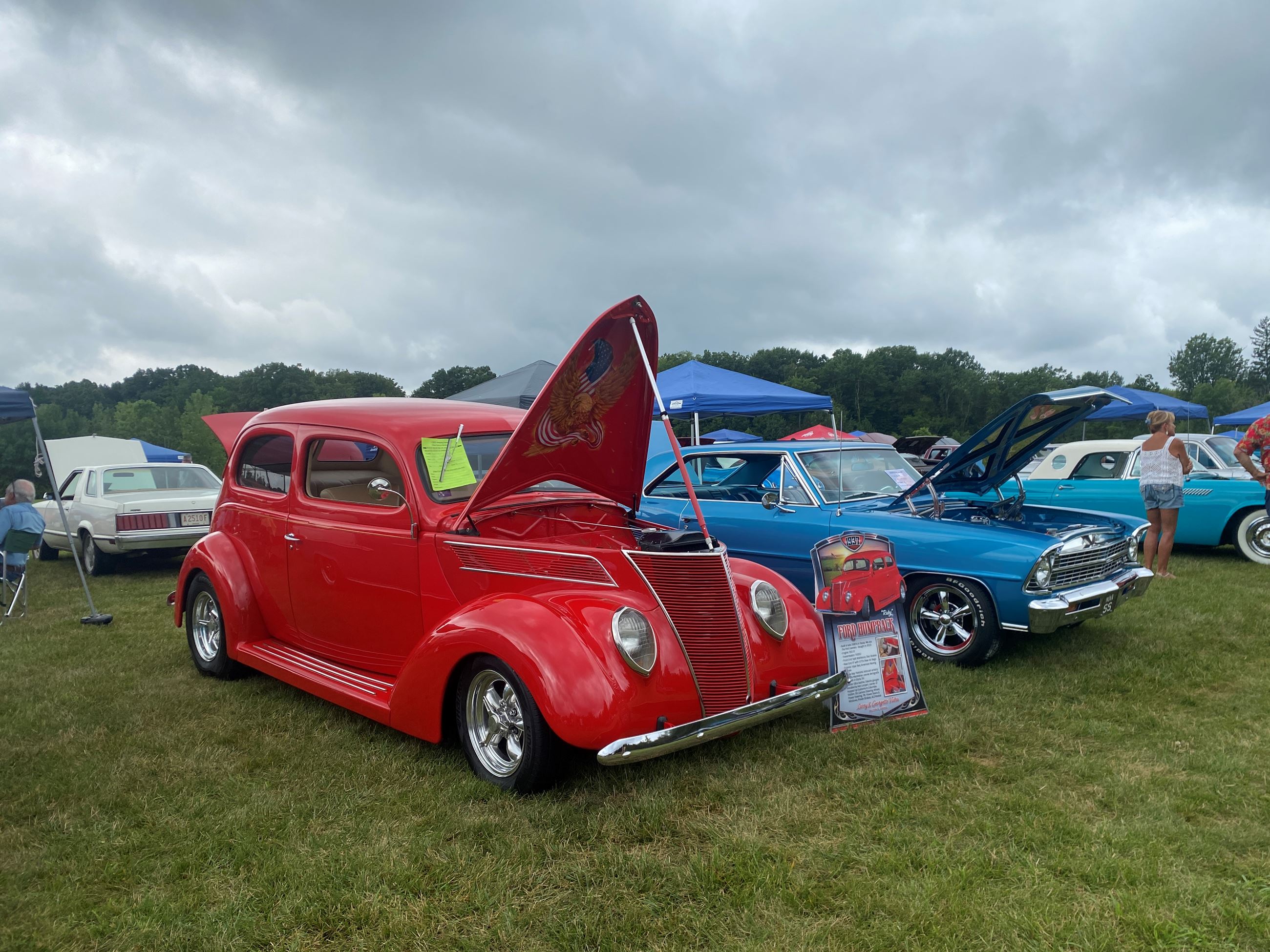 Rows of Vintage Cars With Their Hoods Open at Car Show 2025