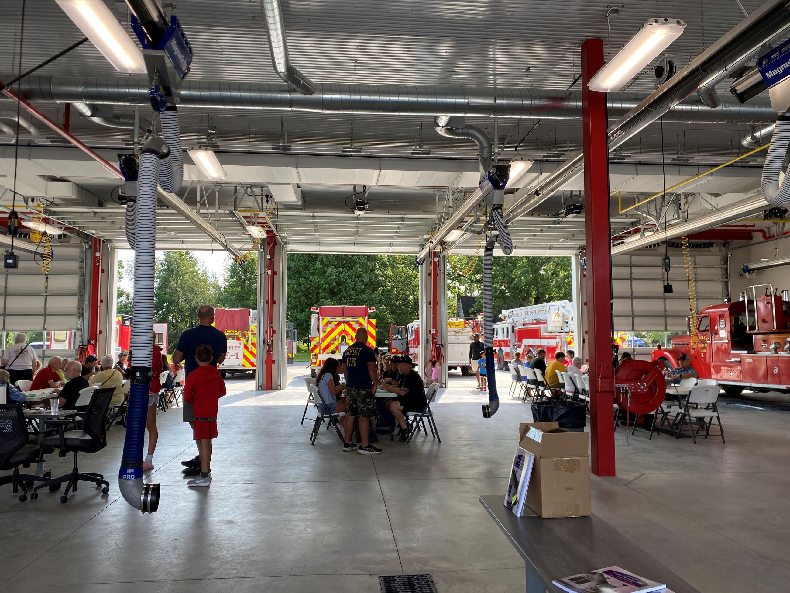Residents Enjoying Breakfast at multiple tables lined up at Copley Fire & Rescue Pancake Breakfast taking place at the Copley Safety Center