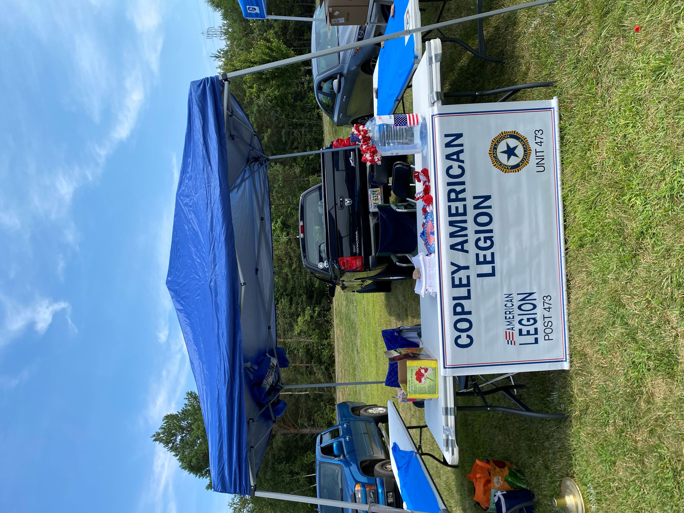 Vendors Set Up Under a Blue Tent At Copley Community Park on Saturday For Heritage Days 2025