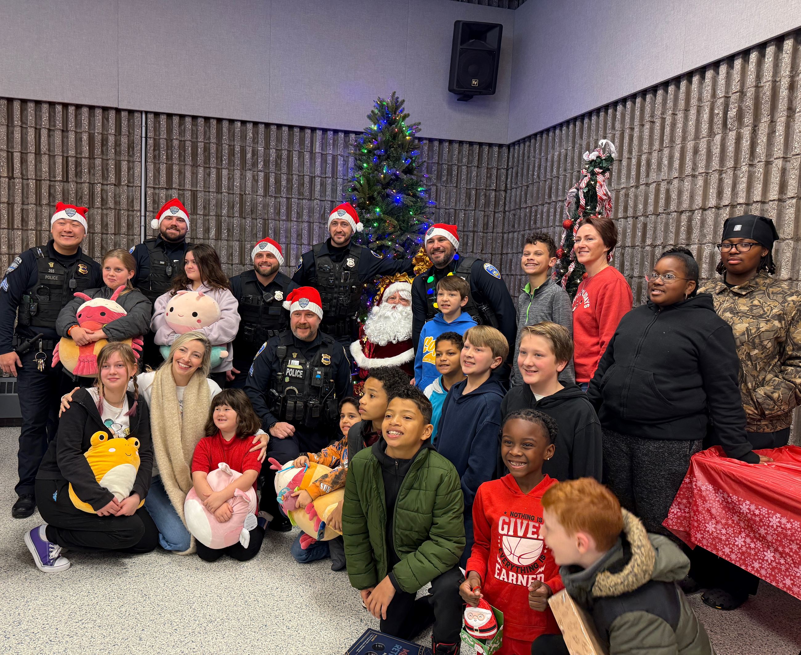 A group of People stand around santa claus