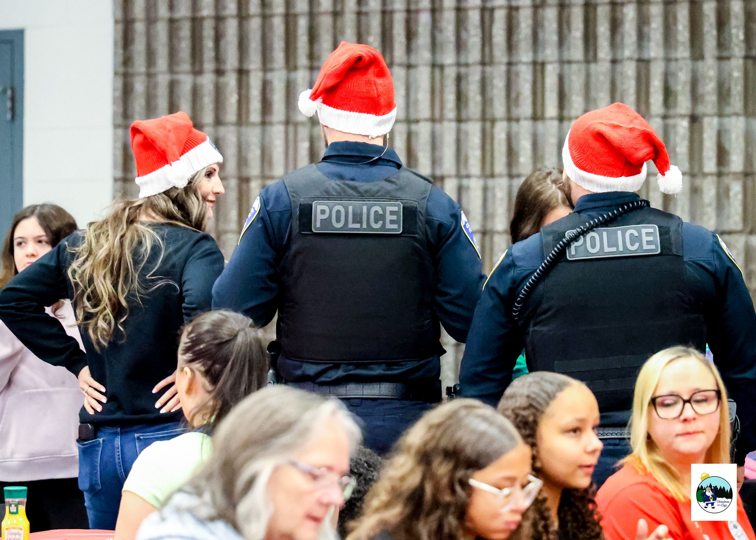 A group of people are seen eating in the bottom of the picture, in the background 3 people are stand