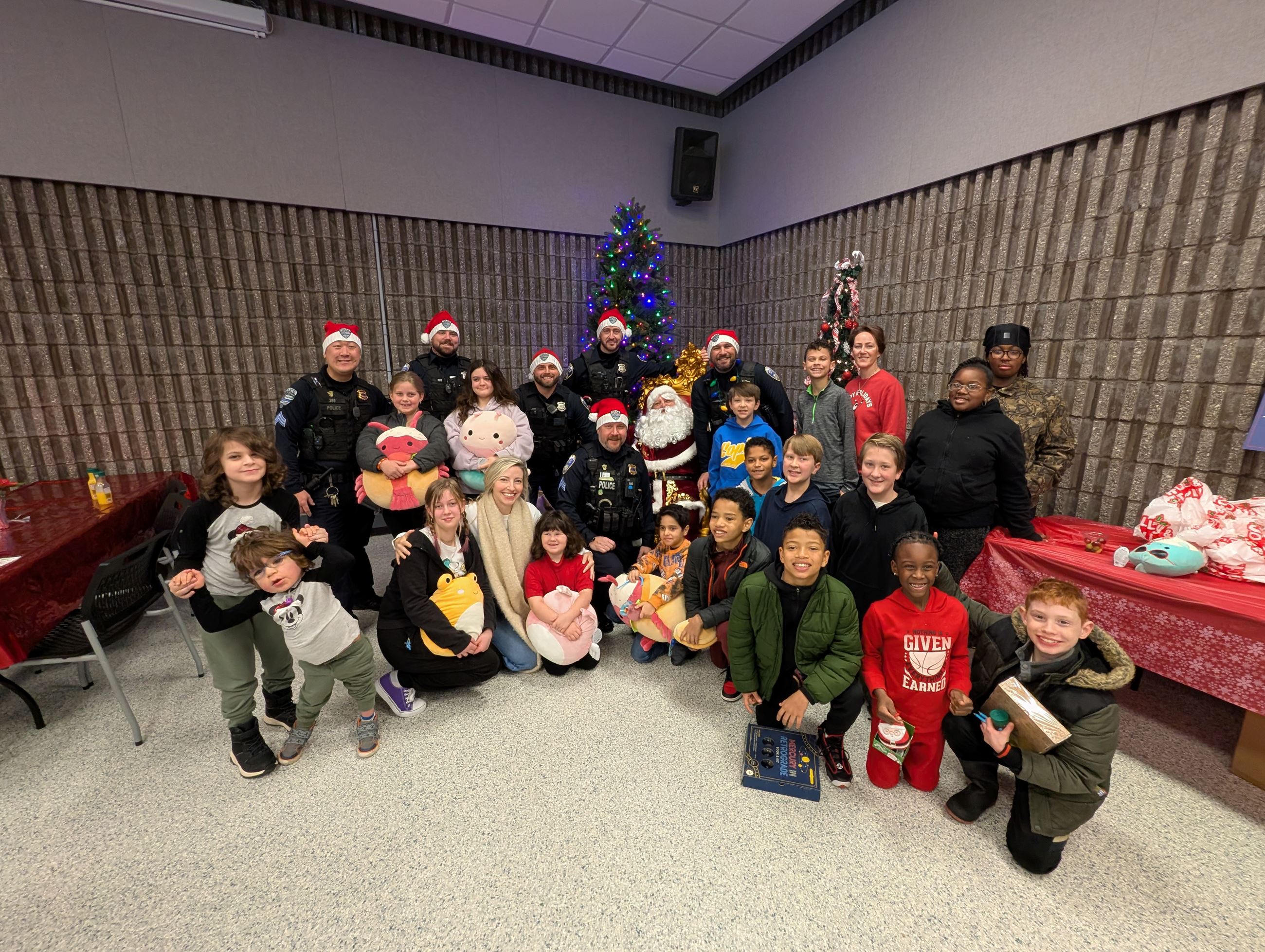 A group of People stand around santa claus